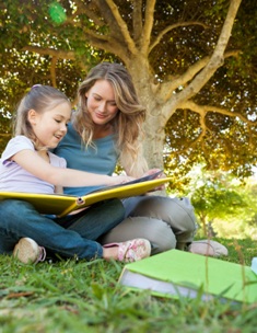 Au pair in Australia reading a book to girl